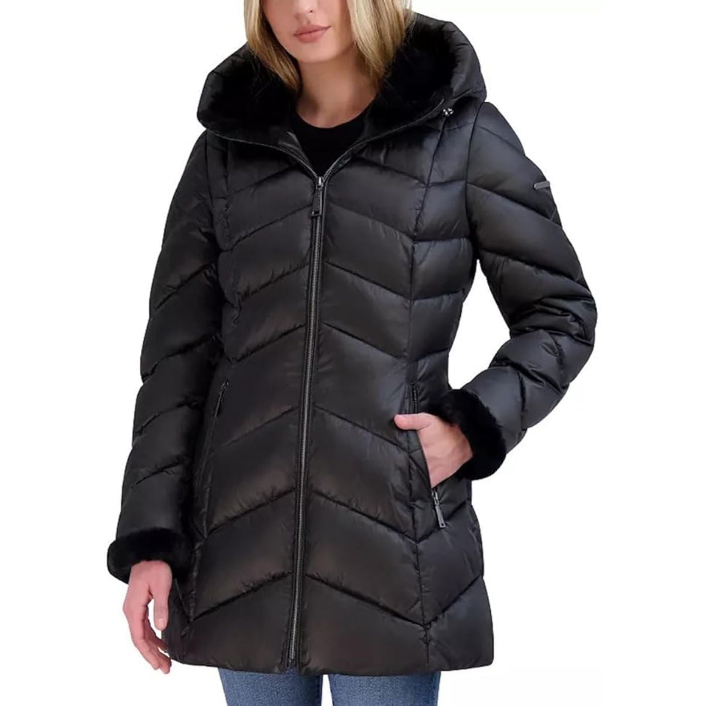 Black puffer coat worn by a person on a white background