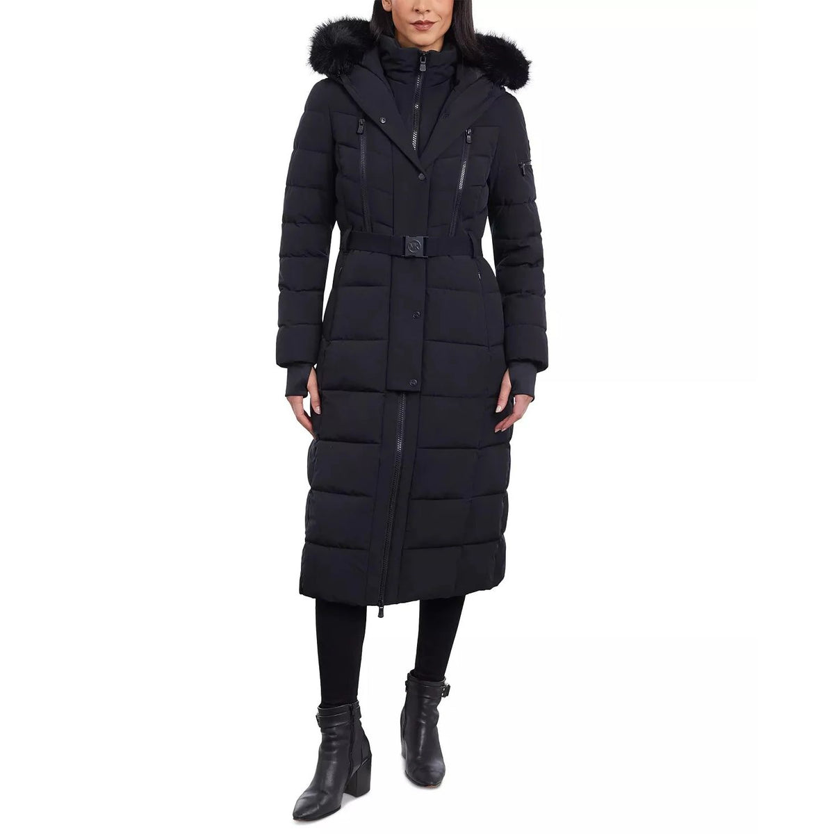 Person wearing a long black puffer coat with a fur-lined hood on a white background