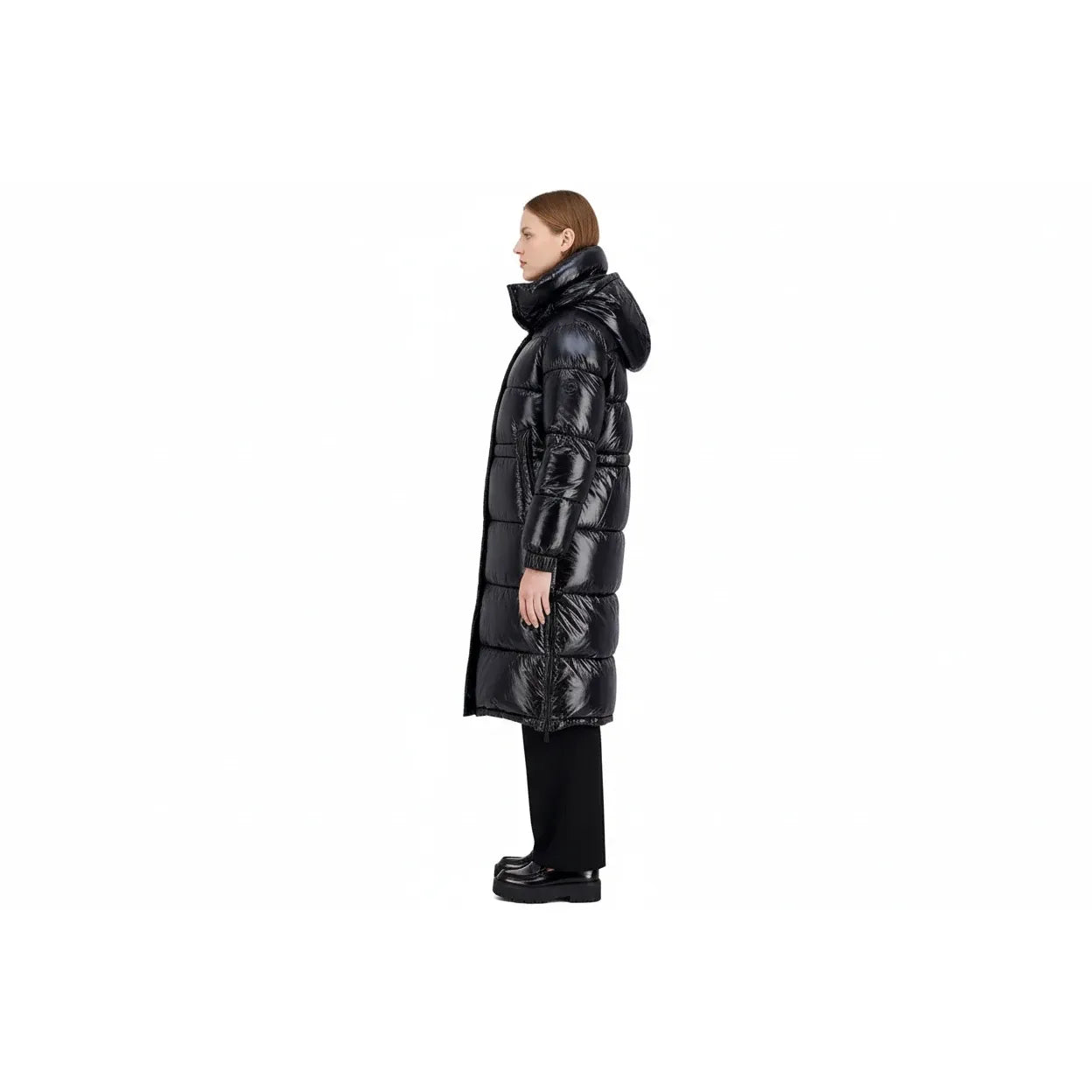 Person wearing a long black puffer coat on a white background