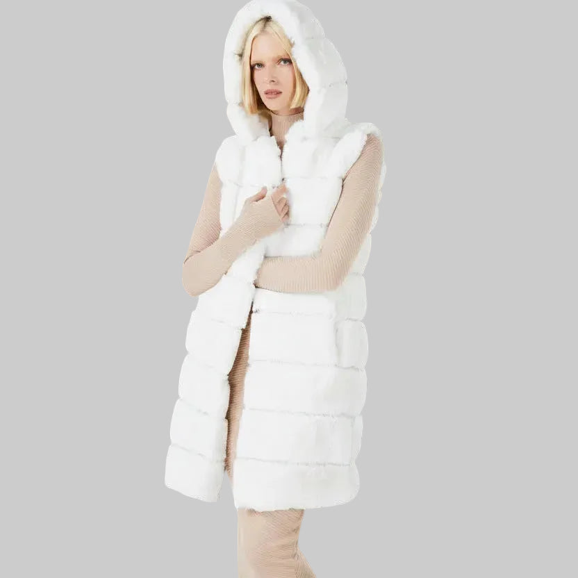 Woman wearing a white puffer vest against a dark background