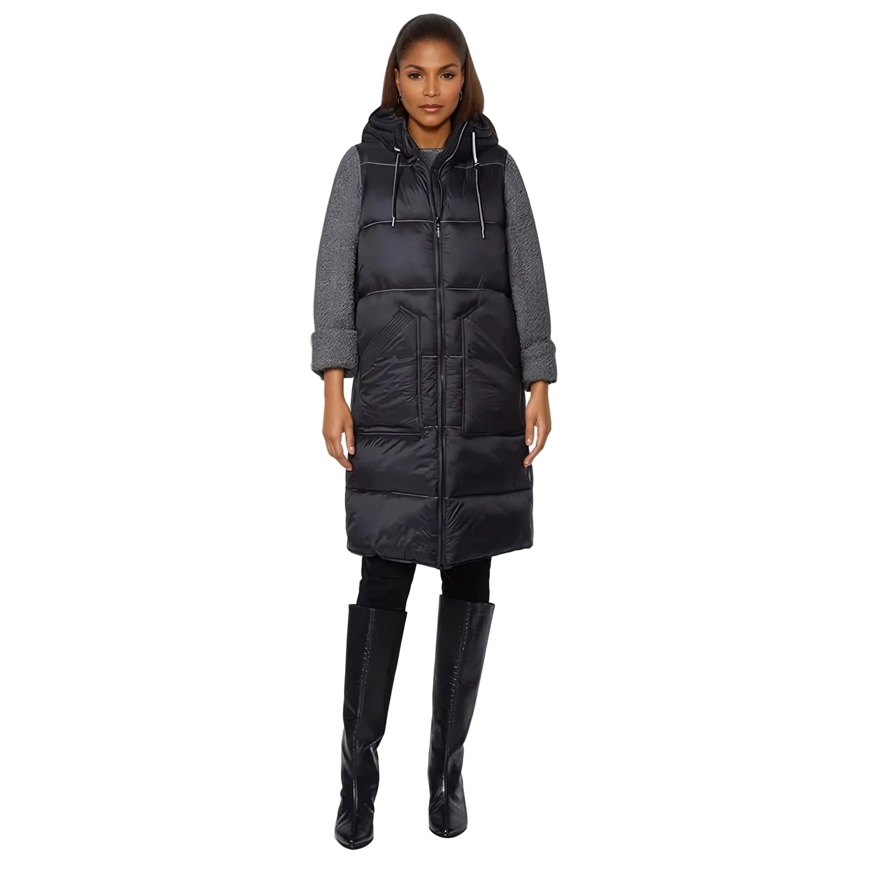 Woman wearing a long black puffer coat with a gray hoodie on a white background
