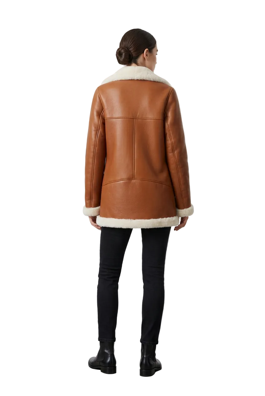 A model viewed from the back wearing a brown leather shearling jacket with a cream-colored collar and hem, paired with black pants and black boots, set against a minimalist studio background.