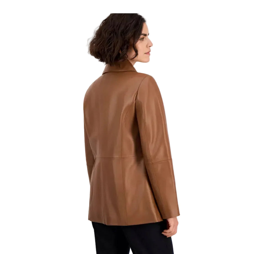 A woman shown from the back wearing a smooth, structured brown faux-leather blazer with black trousers, set against a plain light gray studio background.