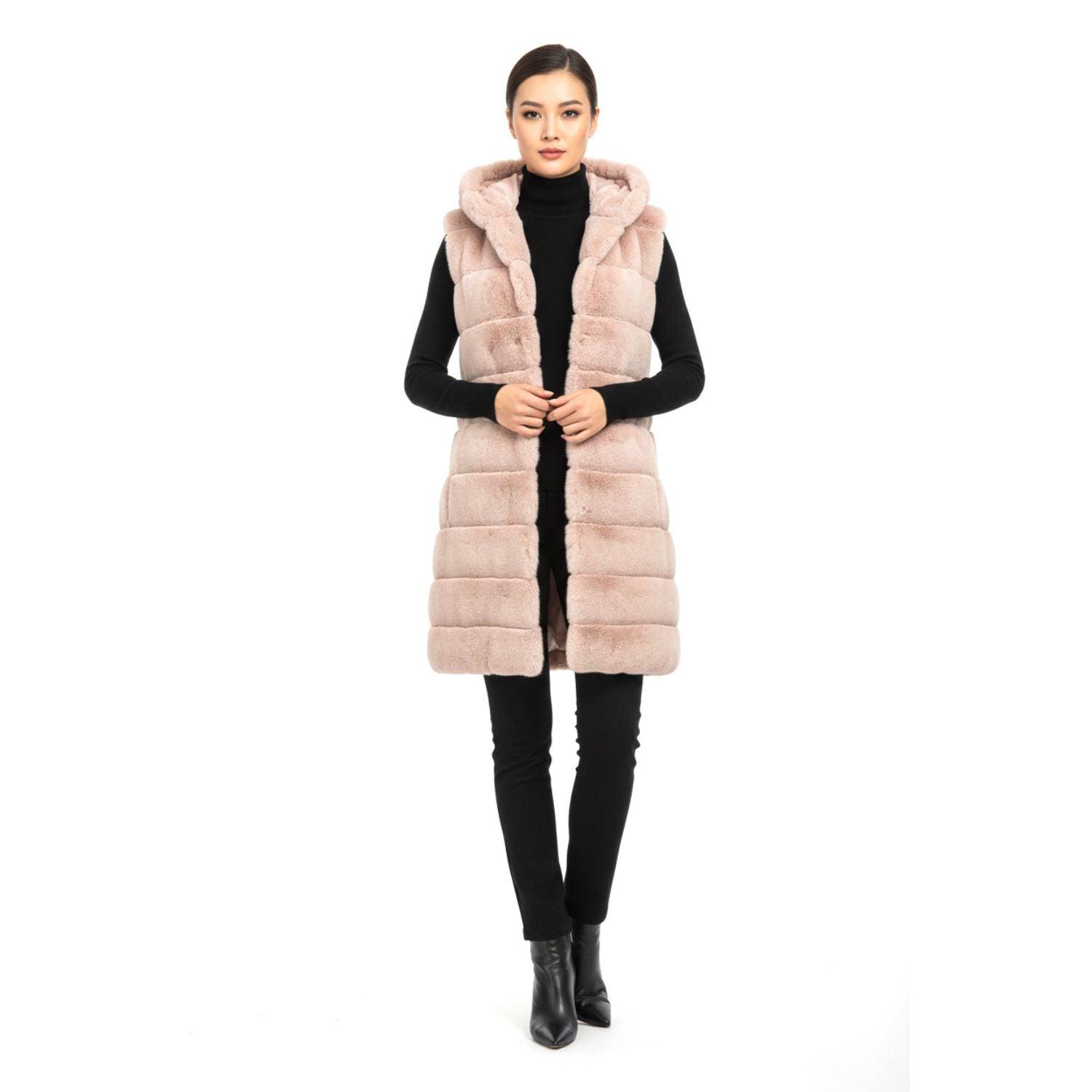 Woman wearing a long pink fur vest on a white background