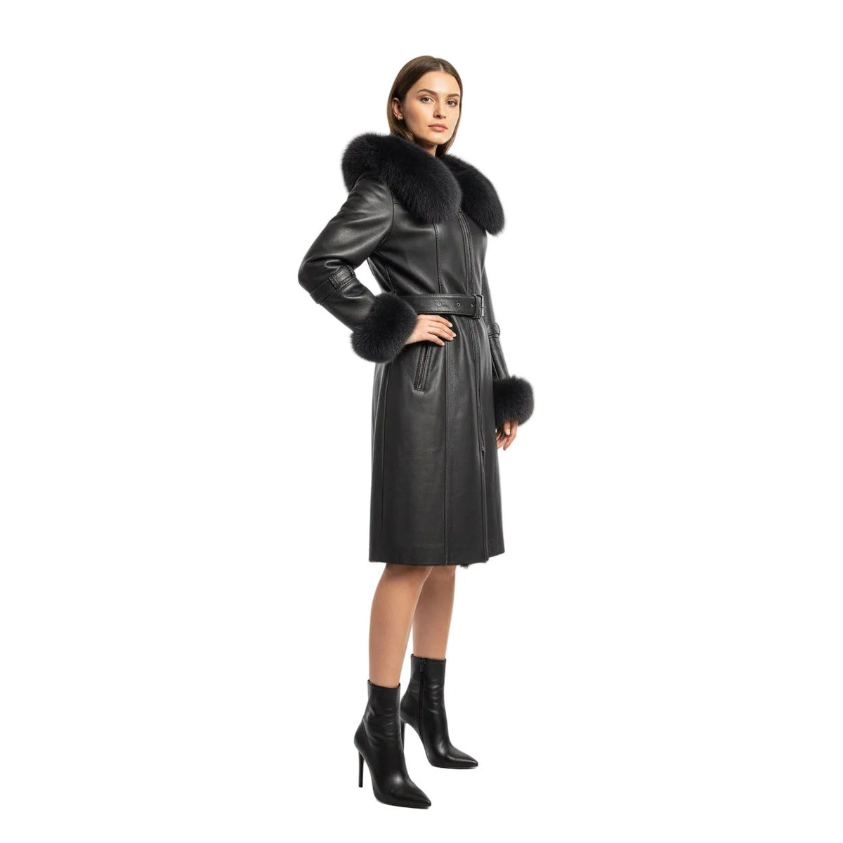 A gray leather coat with a large dark gray fur collar, belt, and matching fur-trimmed cuffs, displayed on a stand in a store interior.