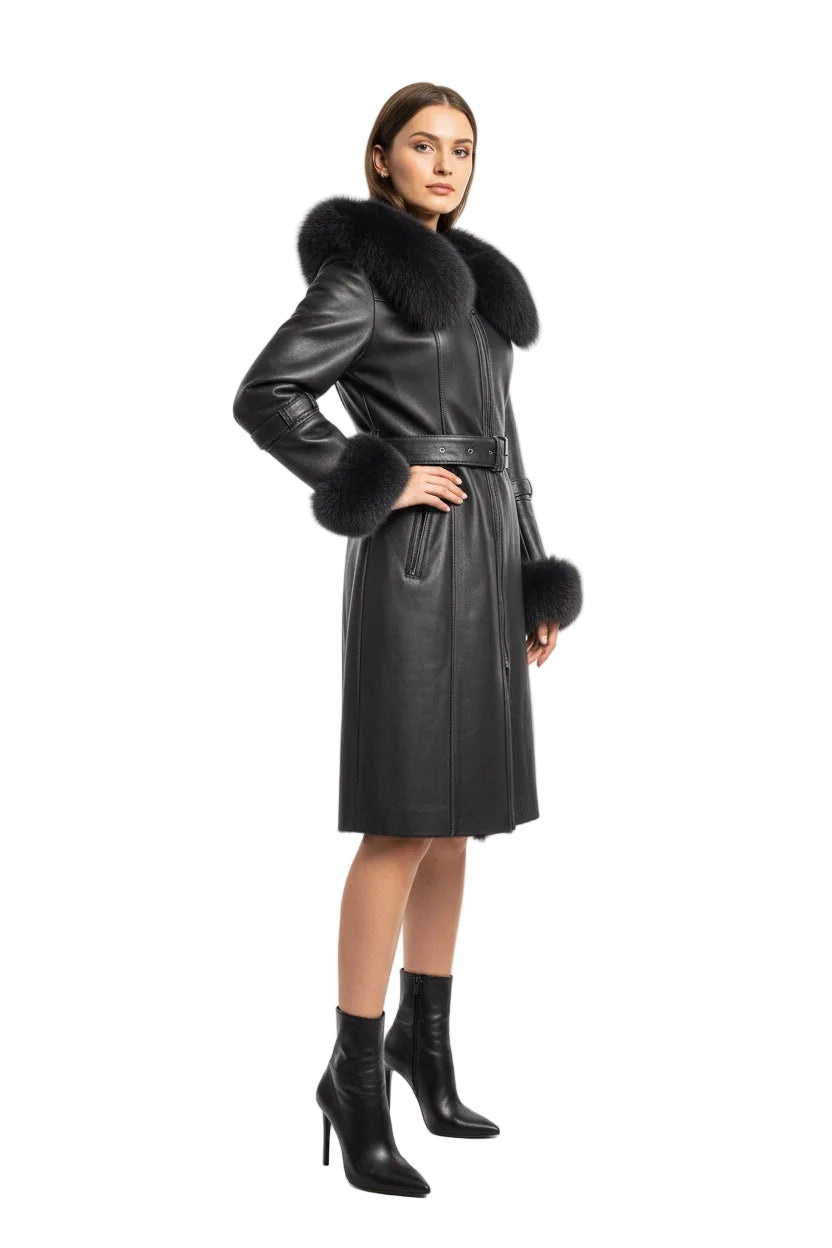 A gray leather coat with a large dark gray fur collar, belt, and matching fur-trimmed cuffs, displayed on a stand in a store interior.