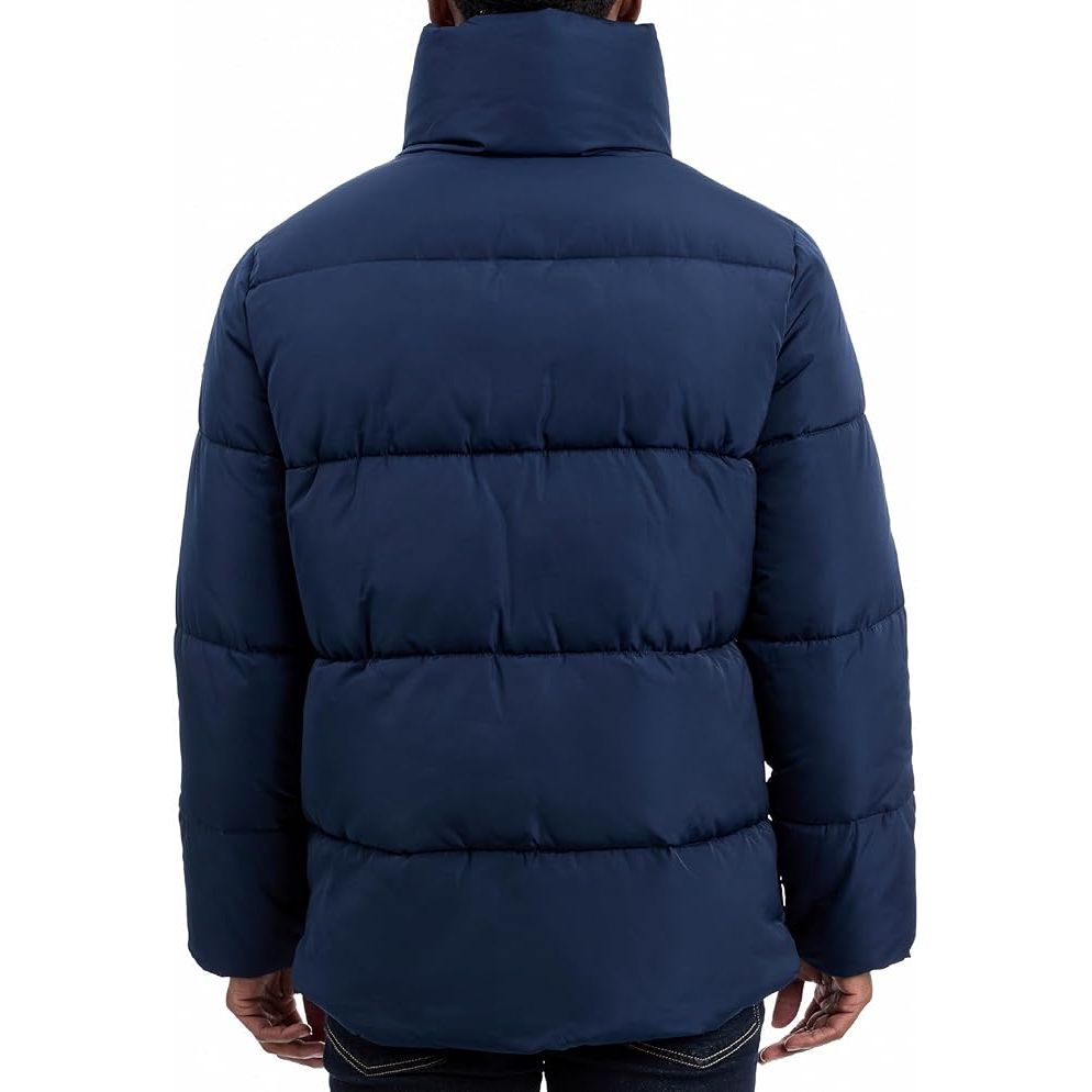 Navy blue puffer jacket worn by a person on a white background