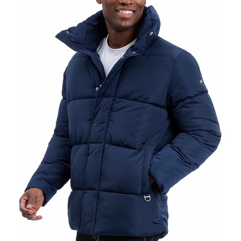 Man wearing a navy blue puffer jacket on a white background