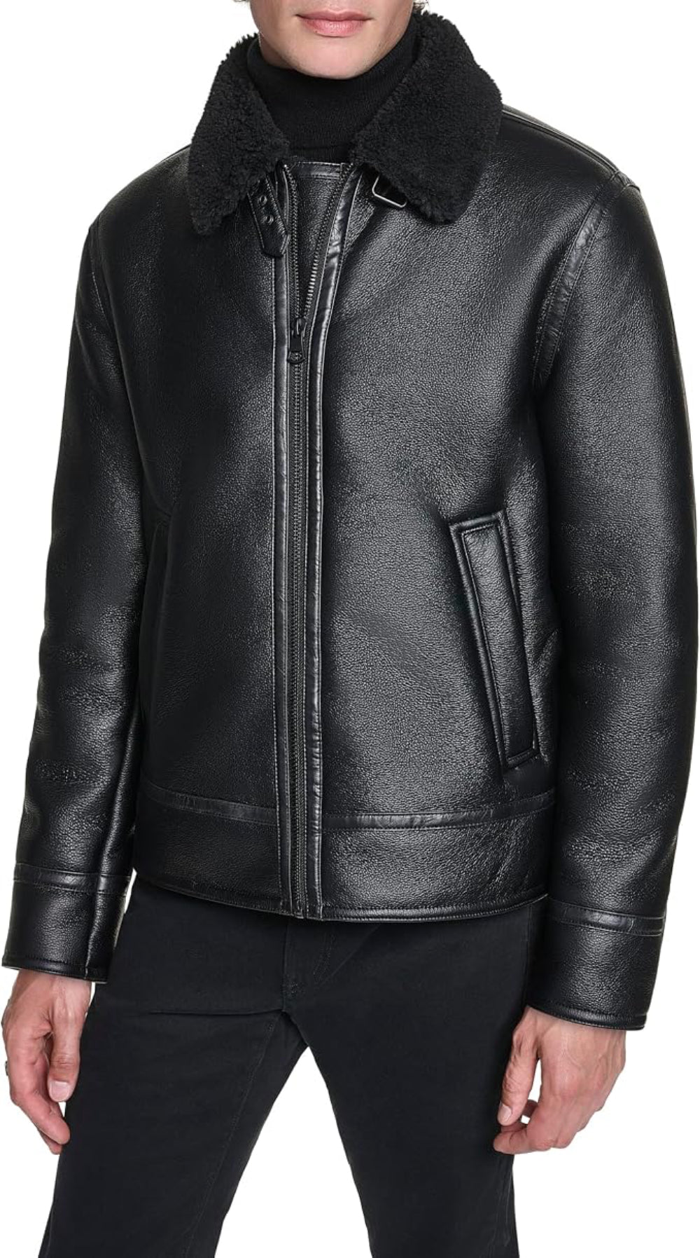 A black leather aviator-style jacket with a black shearling-style collar, worn by a model over a black turtleneck and black pants, shown against a plain white background.